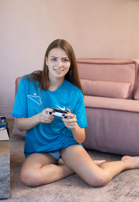 Fit teen model Nana playing video games and teasing in thong panties