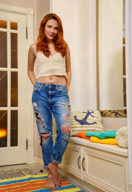 Redhead beauty Janey strips jeans to reveal beautiful shaved pussy - 1 of 12