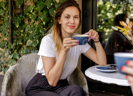 Brunette with perky tits spreads legs to reveal shaved pussy in bedroom