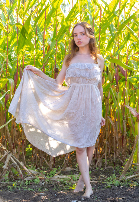 Cute redhead beauty Rinna Ly showing perky breasts in nature