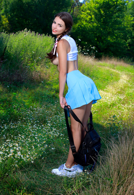 Slender cutie Feolla undressing and posing nude in nature - 5 of 16