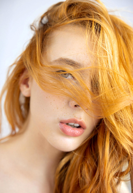 Stunning redhead model Lila Rouge teasing in sheer bra and panties