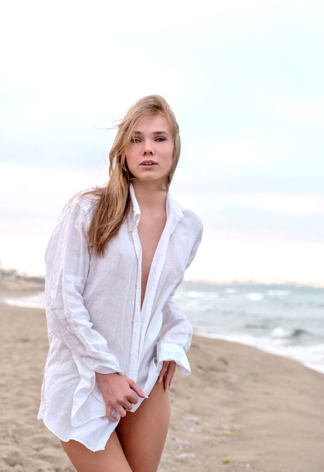 Blonde babe Luise strips shirt on beach before spreading legs on sand - 2 of 12