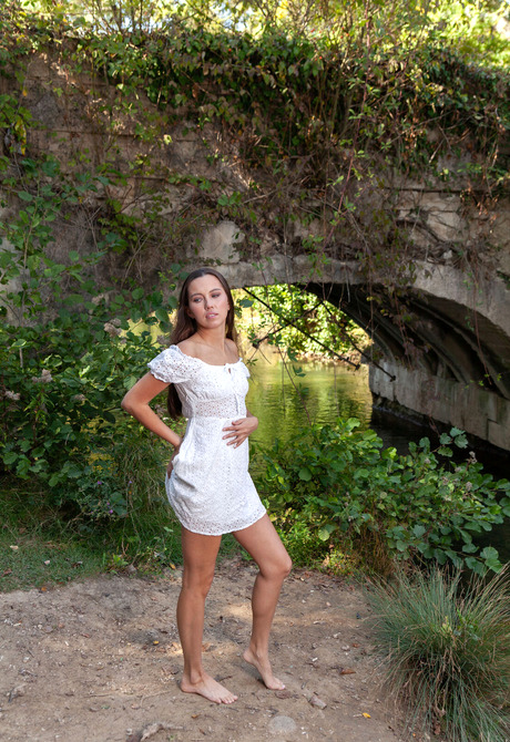 Brunette babe Zarusha strips off white dress in park and displays ass with tan lines - 2 of 12