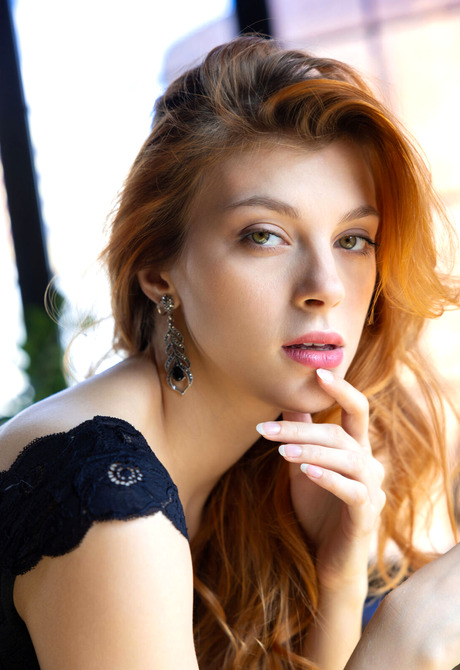 Redhead beauty Naty Evans teases with small tits while flaunting sexy figure