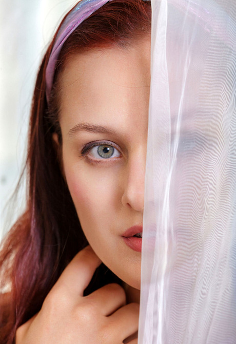 Redhead Olivia Honey teases with feet while revealing perky tits and shaved slit