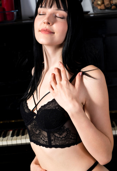 Horny pianist Amelia Riven wears black lingerie and stockings during fantastic teasing