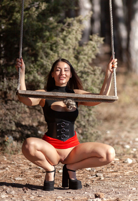 Join Sumiko posing on a swing in high heels with her big tits out before spreading - 3 of 16